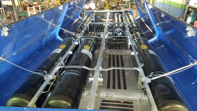 Open cylinder shields on top of a CNG bus.